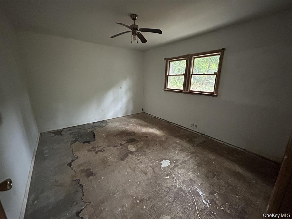 277 Prince Road Rocky Point, NY 11778 - Photo 11 of 19 Spare room featuring ceiling fan and unfinished concrete floors