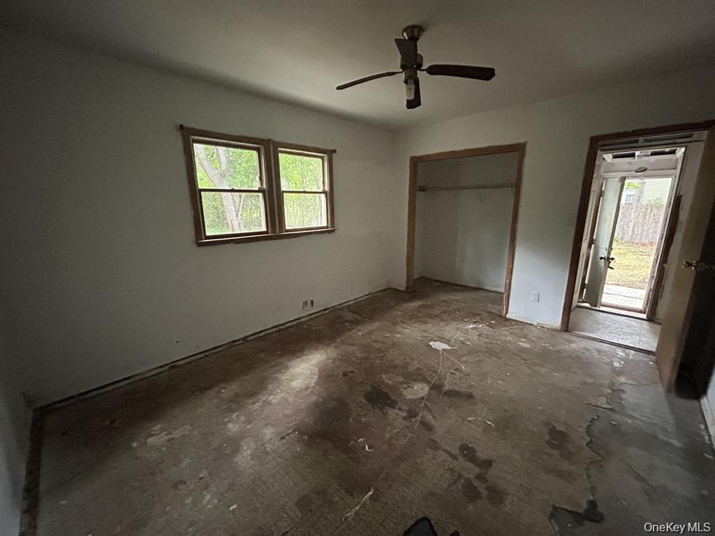 277 Prince Road Rocky Point, NY 11778 - Photo 12 of 19 Unfurnished bedroom with a closet, a ceiling fan, and concrete floors