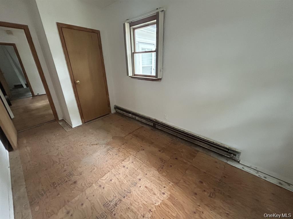 277 Prince Road Rocky Point, NY 11778 - Photo 14 of 19 Unfurnished bedroom with a baseboard heating unit and a closet