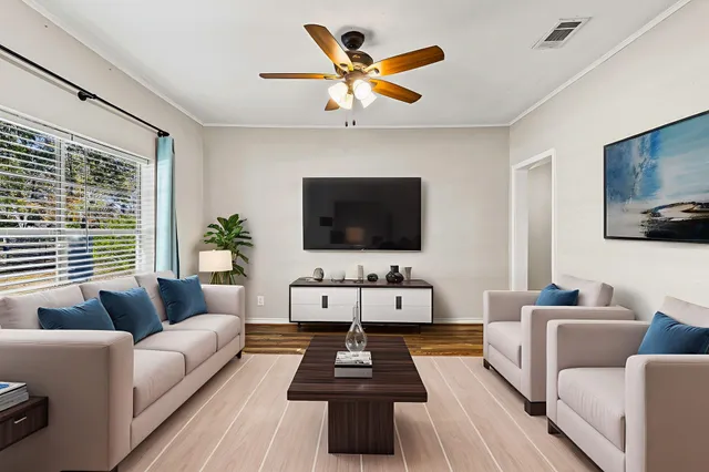 a living room with furniture and a flat screen tv