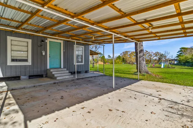 a view of a backyard with wooden fence