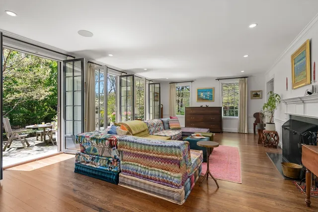 a bedroom with furniture and large windows