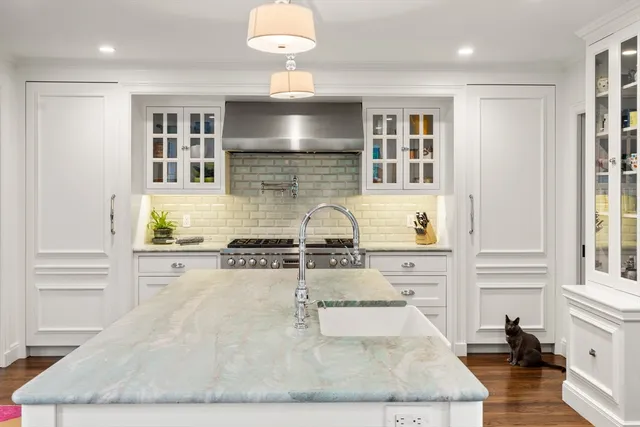 a kitchen with sink refrigerator and stove