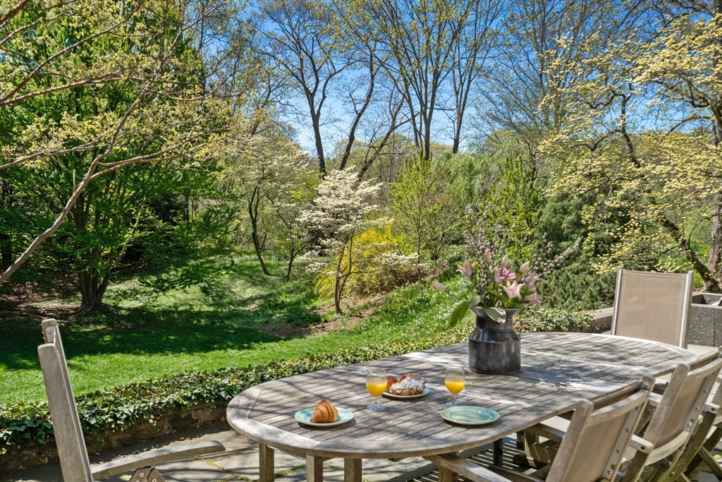 21 Sargent Crossway Brookline, MA 02445 - Photo 10 of 36 a wooden table and chairs in the garden