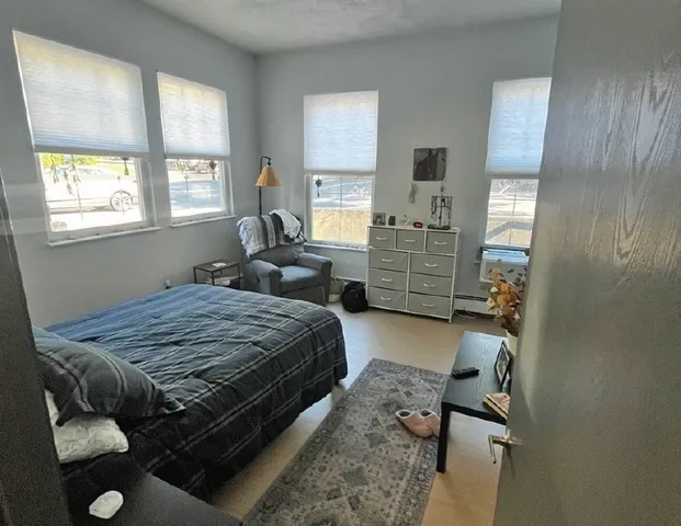 a bedroom with a bed and a couch