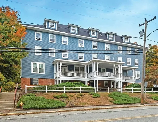 a front view of a building with a yard