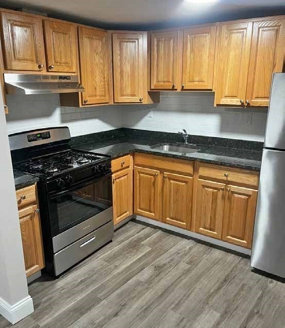 135 Main Street Upton, MA 01568 - Photo 8 of 19 a kitchen with granite countertop wooden cabinets and a stove top oven