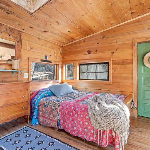10000 Little Applegate Road Jacksonville, OR 97530 - Photo 44 of 141 a bedroom with bed and wooden floor