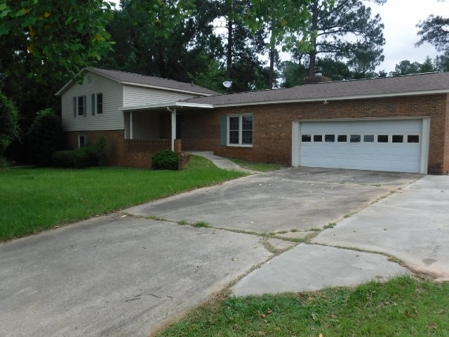 1608 Macon Road Perry, GA 31069 - Photo 1 of 11 a view of a house with a yard and large tree