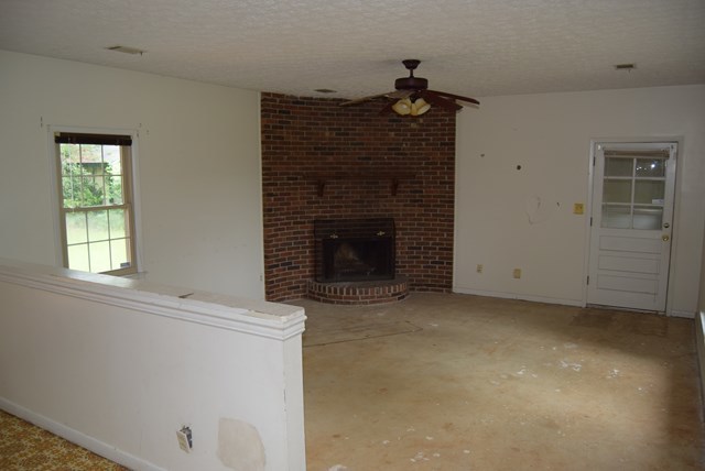 1608 Macon Road Perry, GA 31069 - Photo 2 of 11 a view of empty room with a fireplace