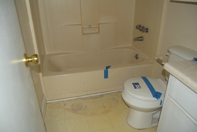 1608 Macon Road Perry, GA 31069 - Photo 8 of 11 a white toilet sitting next to a bath tub