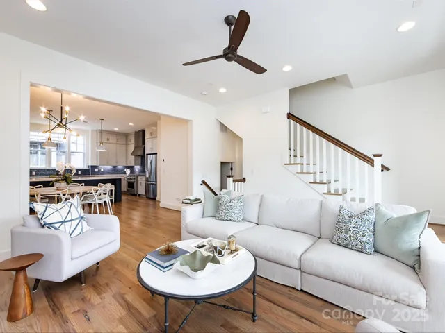 a living room with furniture kitchen view and a table