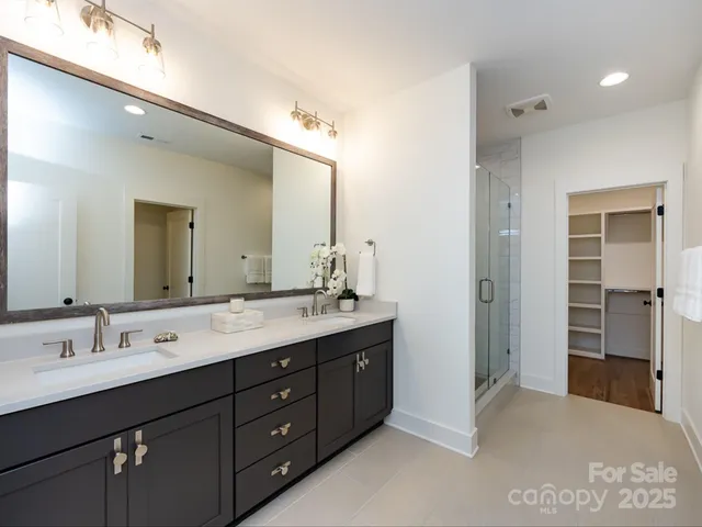 a spacious bathroom with a double vanity sink mirror and double