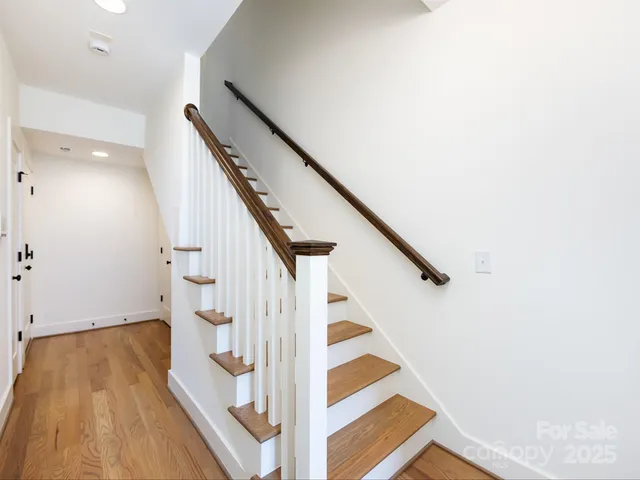 a view of entryway and hall with wooden floor