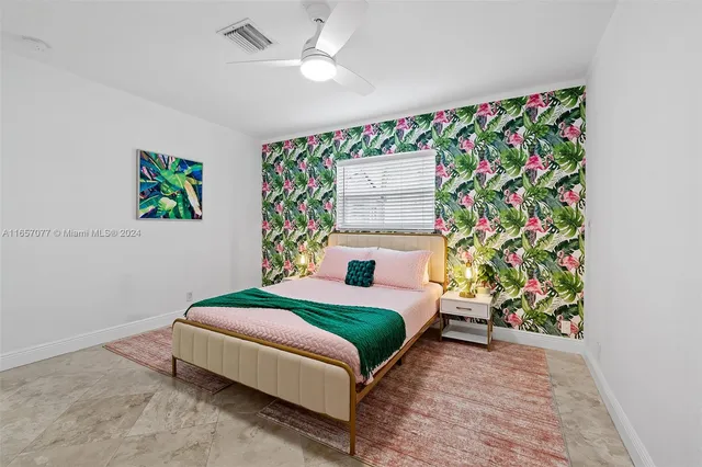 a bedroom with a bed mirror and a window