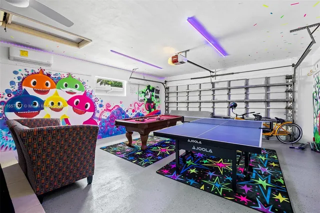 a living room with furniture and a baby crib