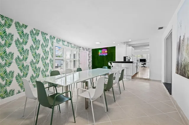 a view of a dining room with furniture and a floor to ceiling window