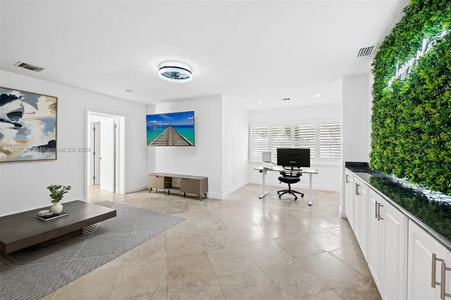 a living room with furniture and a potted plant