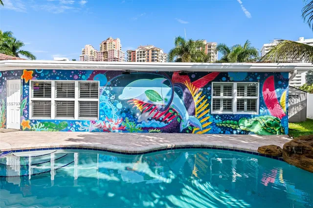 a view of a park with plants and large trees