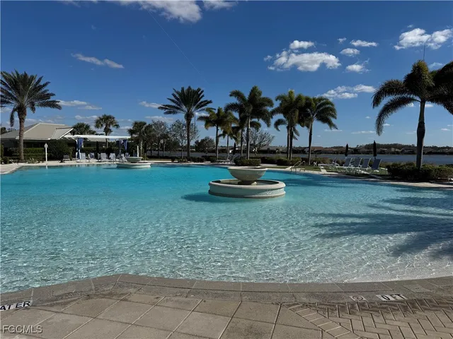 a view of a swimming pool with a table and chairs