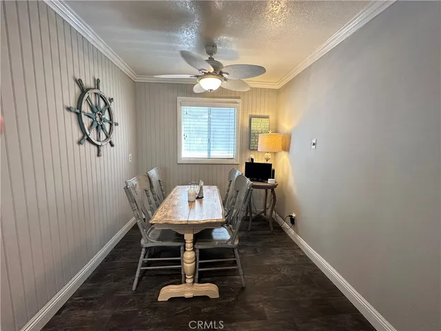 a dining room with wooden floor and a window