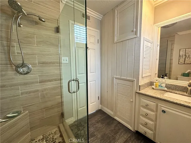 a bathroom with a granite countertop shower mirror and a sink