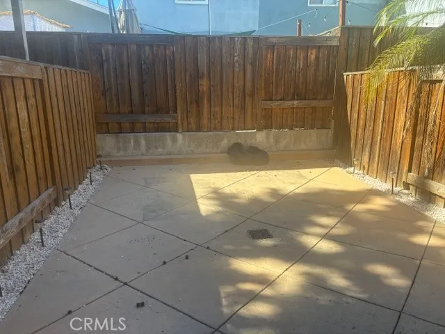 a view of a small space with wooden fence