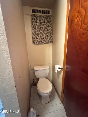 a white toilet sitting next to a shower curtain