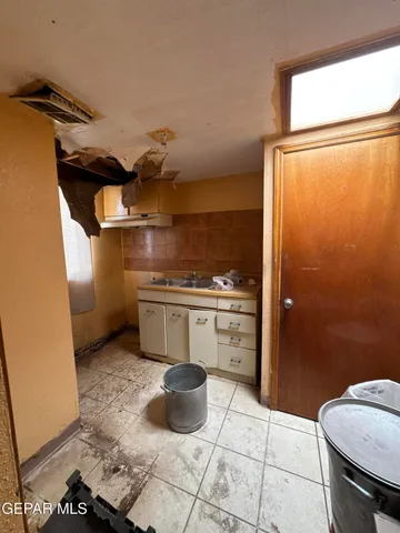 a kitchen with a refrigerator and a stove