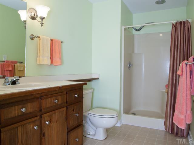 1929 Partridge Berry Drive Raleigh, NC 27606 - Photo 19 of 25 Next to the 2nd bedroom is another full bath with a single vanity and a walk-in shower. Bathroom