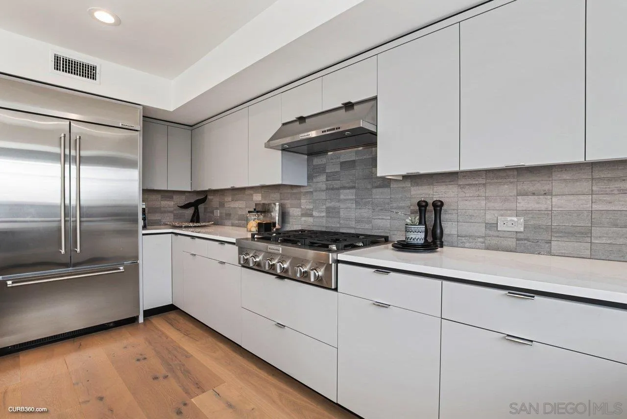 8352 La Jolla Shores Drive La Jolla, CA 92037 - Photo 14 of 33 a kitchen with stainless steel appliances granite countertop a sink a stove and a refrigerator