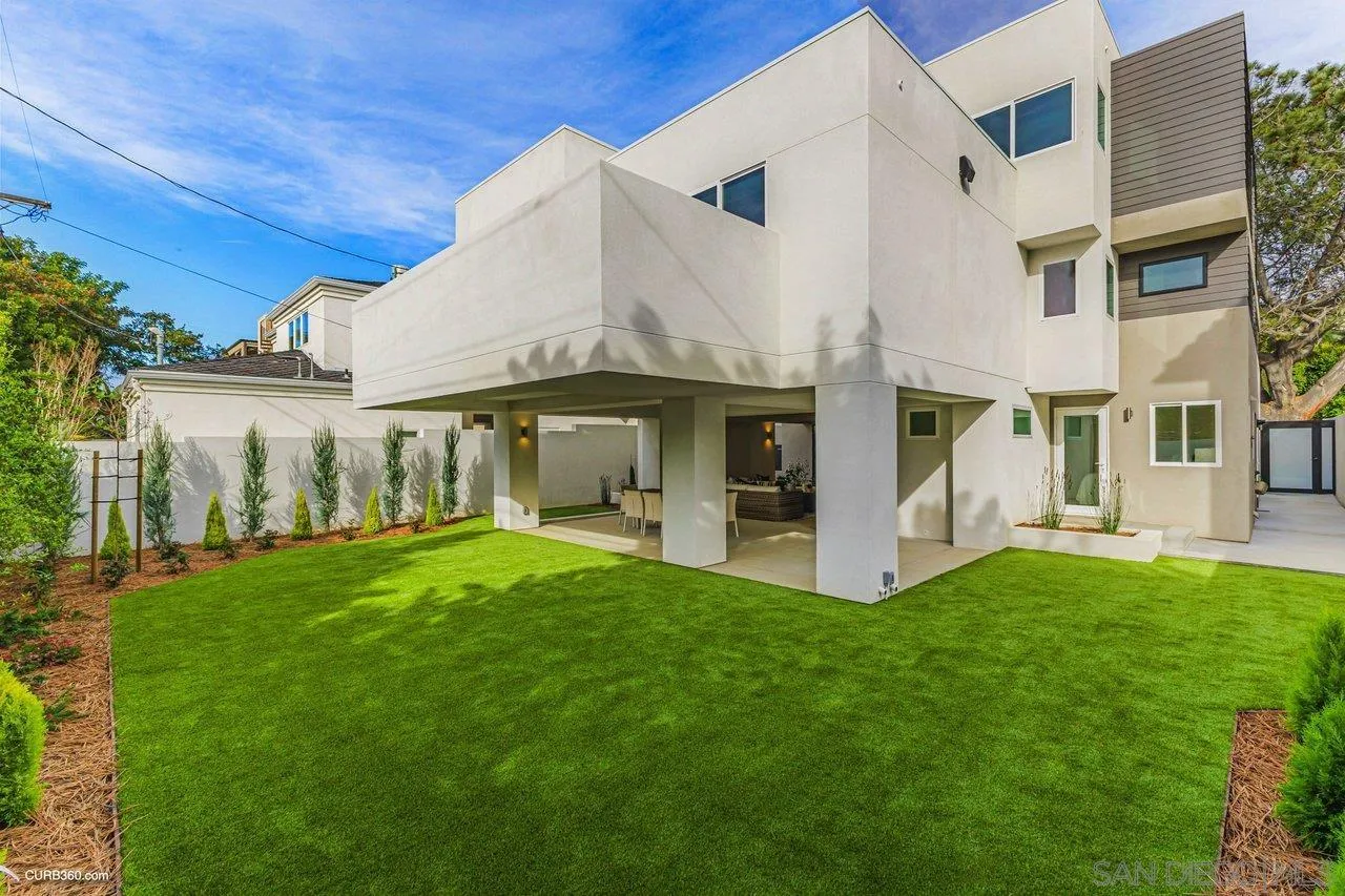 8352 La Jolla Shores Drive La Jolla, CA 92037 - Photo 20 of 33 a view of a white house with a big yard and large trees