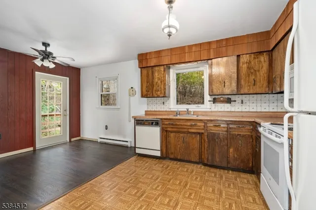 a spacious bathroom with a granite countertop sink a mirror and a bathtub