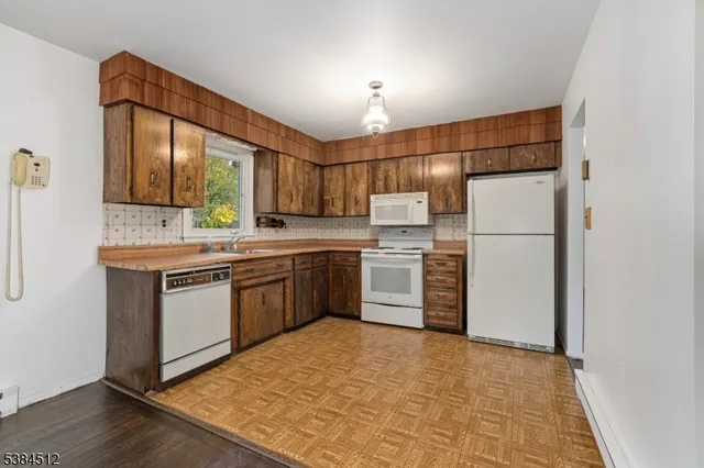 a kitchen with a refrigerator sink and cabinets