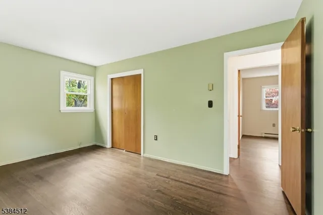 an empty room with windows and closet