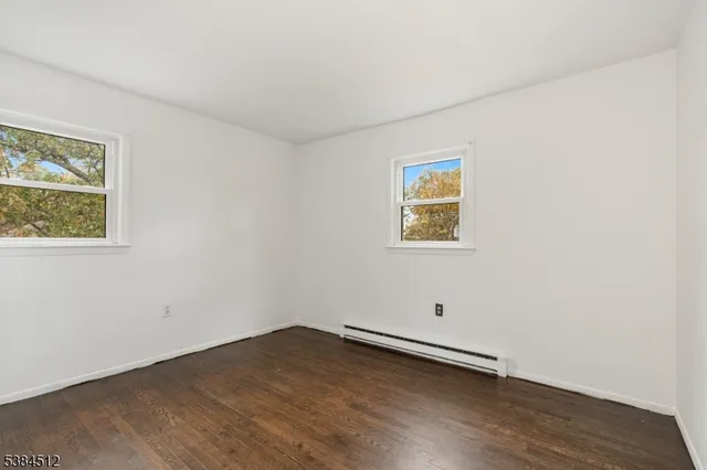 a view of room with wooden floor and window