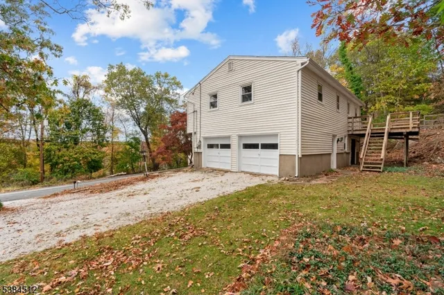 a view of a house with a yard and garage