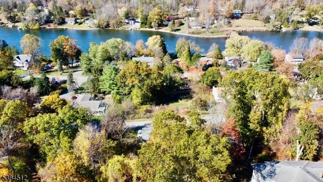 a view of a lake with boats and trees all around