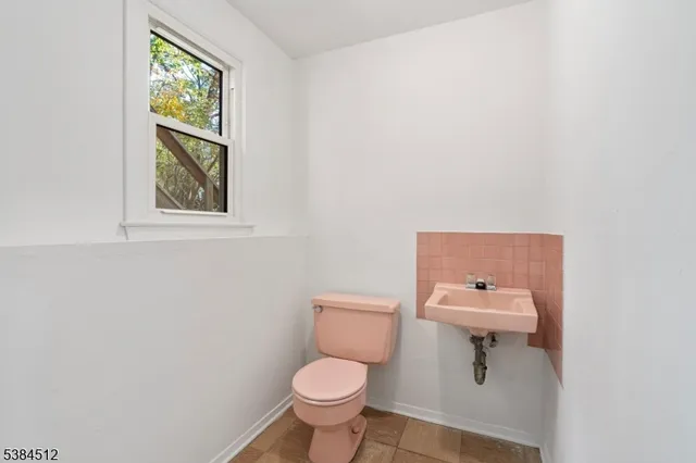 a white toilet sitting next to a bathroom sink
