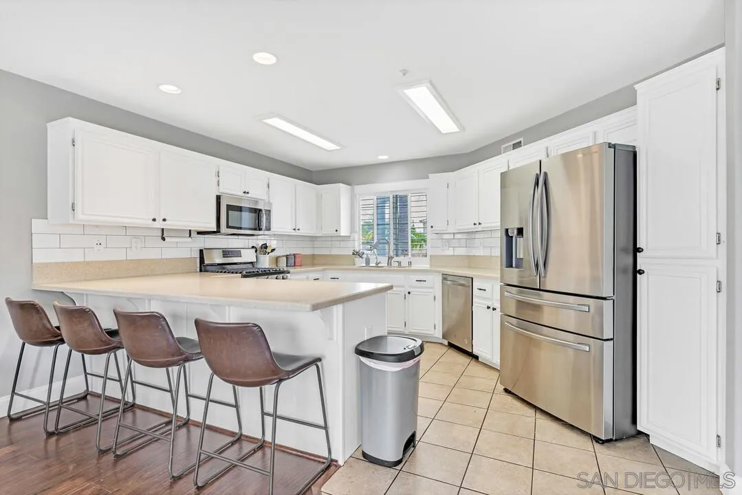 224 Parkside Place Santee, CA 92071 - Photo 14 of 50 a kitchen with stainless steel appliances a refrigerator stove microwave and cabinets