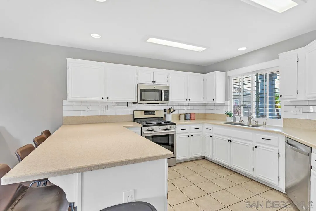 224 Parkside Place Santee, CA 92071 - Photo 16 of 50 a kitchen with granite countertop white cabinets and white appliances