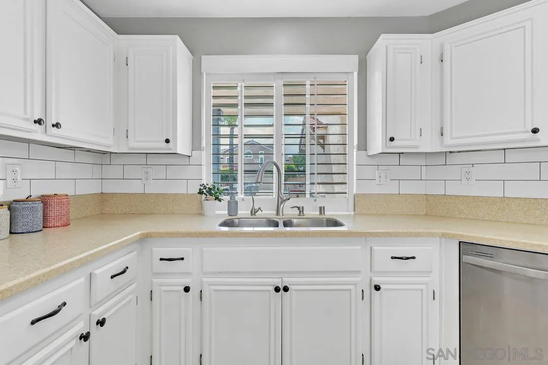 224 Parkside Place Santee, CA 92071 - Photo 17 of 50 a kitchen with granite countertop a sink and a white wooden cabinets