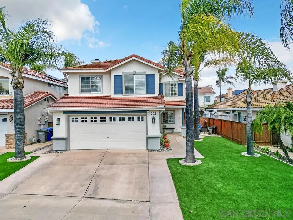 224 Parkside Place Santee, CA 92071 - Photo 2 of 50 a view of a white house with a yard plants and palm trees