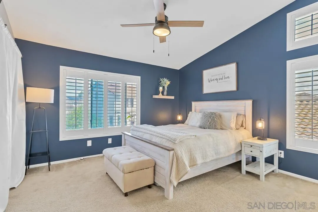 224 Parkside Place Santee, CA 92071 - Photo 21 of 50 a bedroom with a large bed chandelier and a window