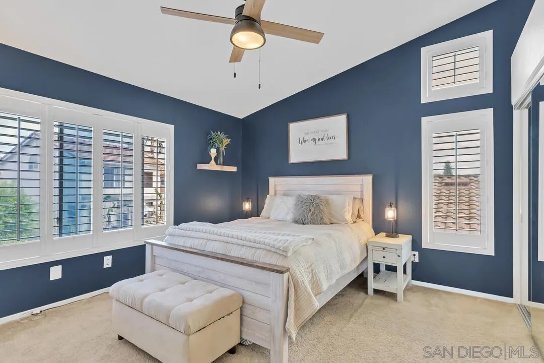 224 Parkside Place Santee, CA 92071 - Photo 22 of 50 a bedroom with a large bed and a chandelier