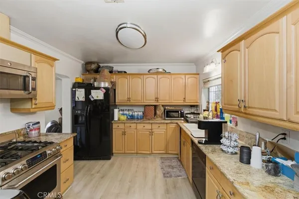 a kitchen with a sink stove and refrigerator