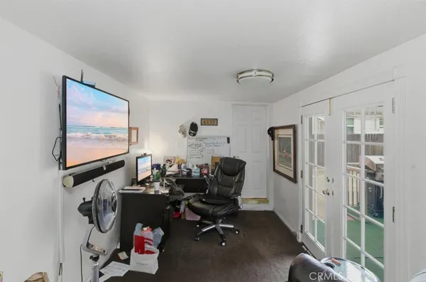 a view of a workspace with furniture and a window