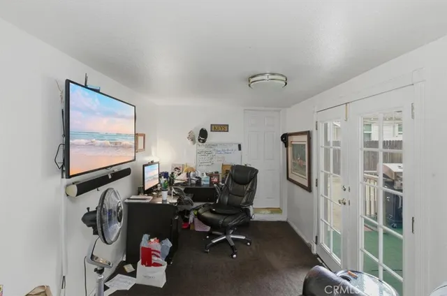 a view of a workspace with furniture and a window