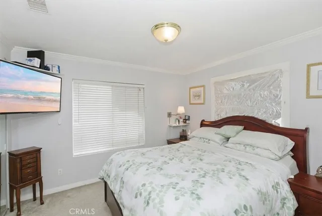 a bedroom with a bed and a lamp next to a window