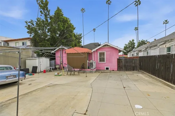 a backyard of a house with sofas fire pit and outdoor seating